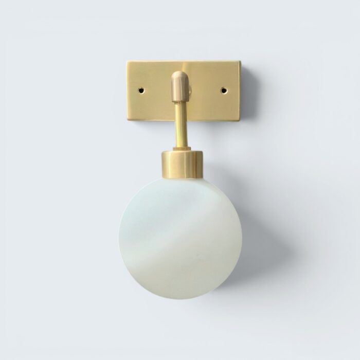 Handmade Globe Wall Light, Minimalist brass wall sconce with a rectangular gold backplate and a round frosted glass globe shade.