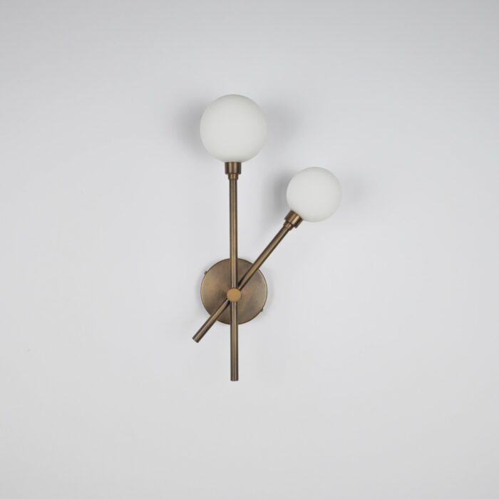 Double Globe Wall Light Modern brass wall sconce with two frosted glass globe lights.