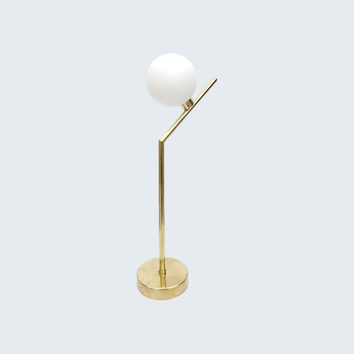 Luxury Stool Lamp featuring a sleek, polished brass finish with a unique angular stem and a white frosted glass globe, perfect for modern home interiors.